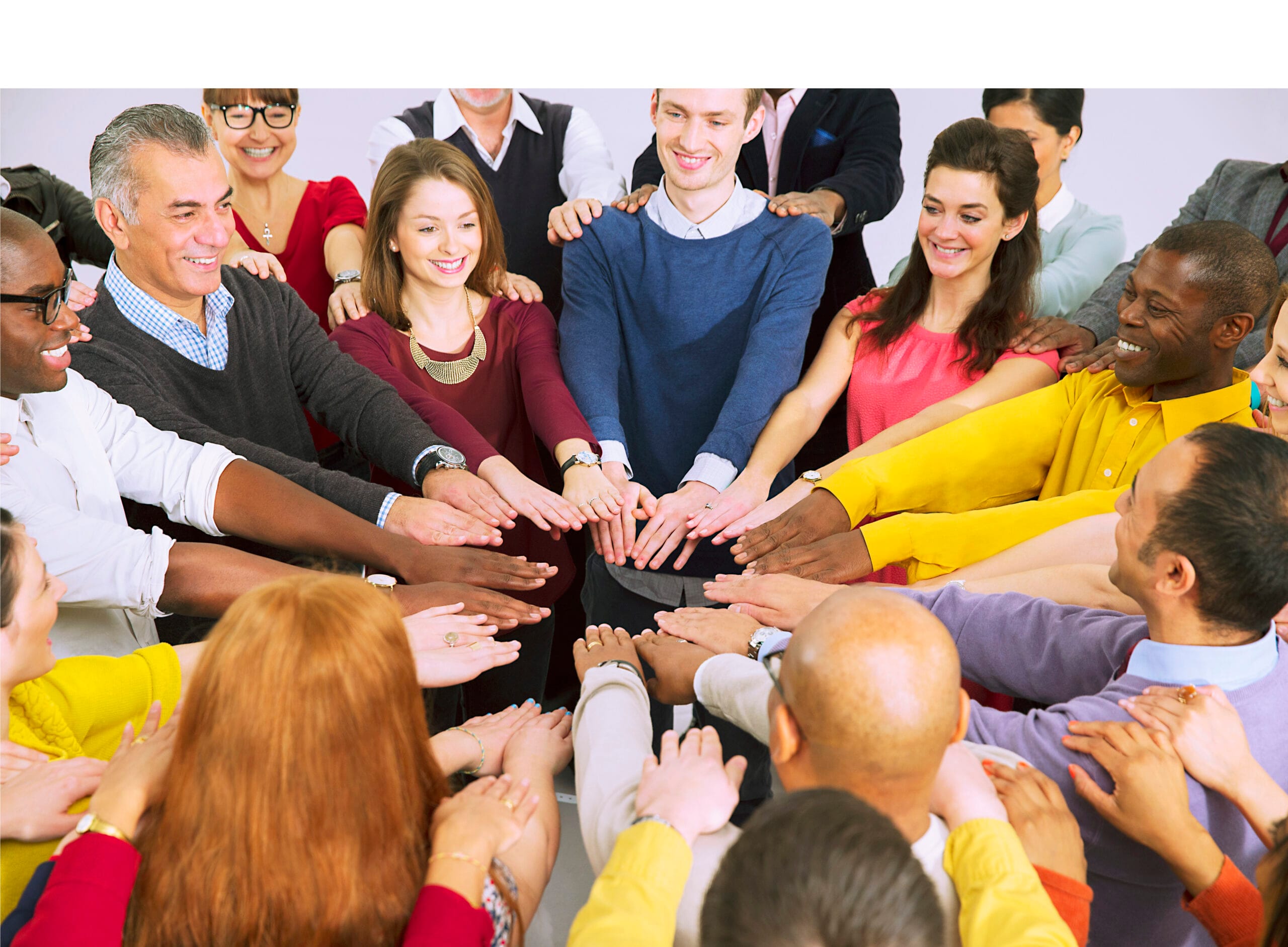 Business people with arms outstretched in huddle